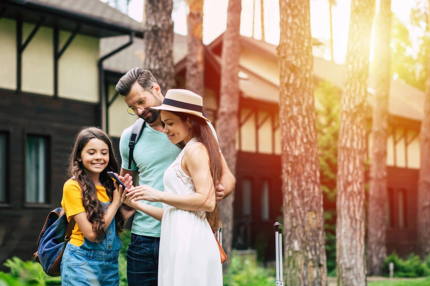 Parents and child looking at phone