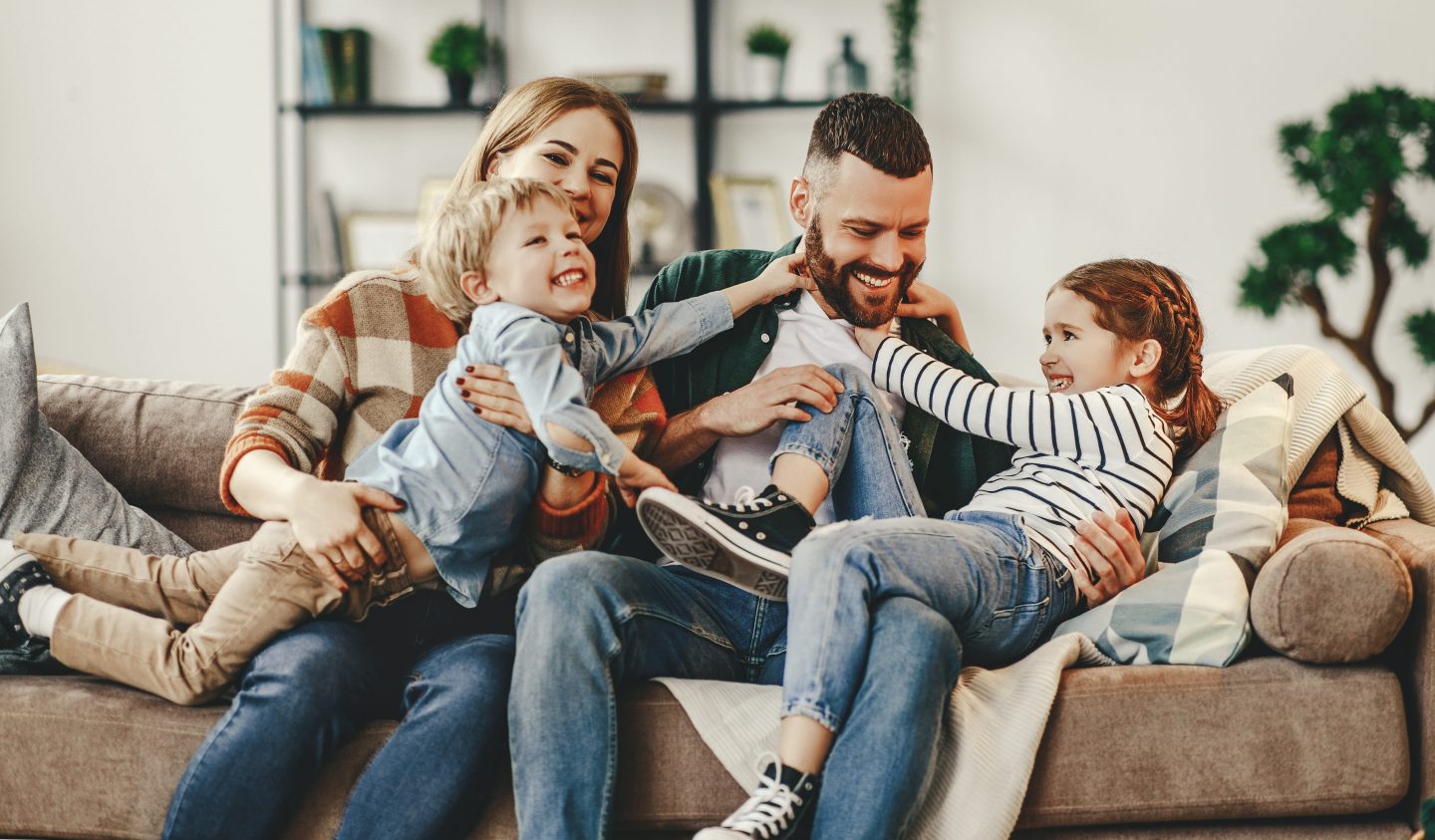 Family playing on couch