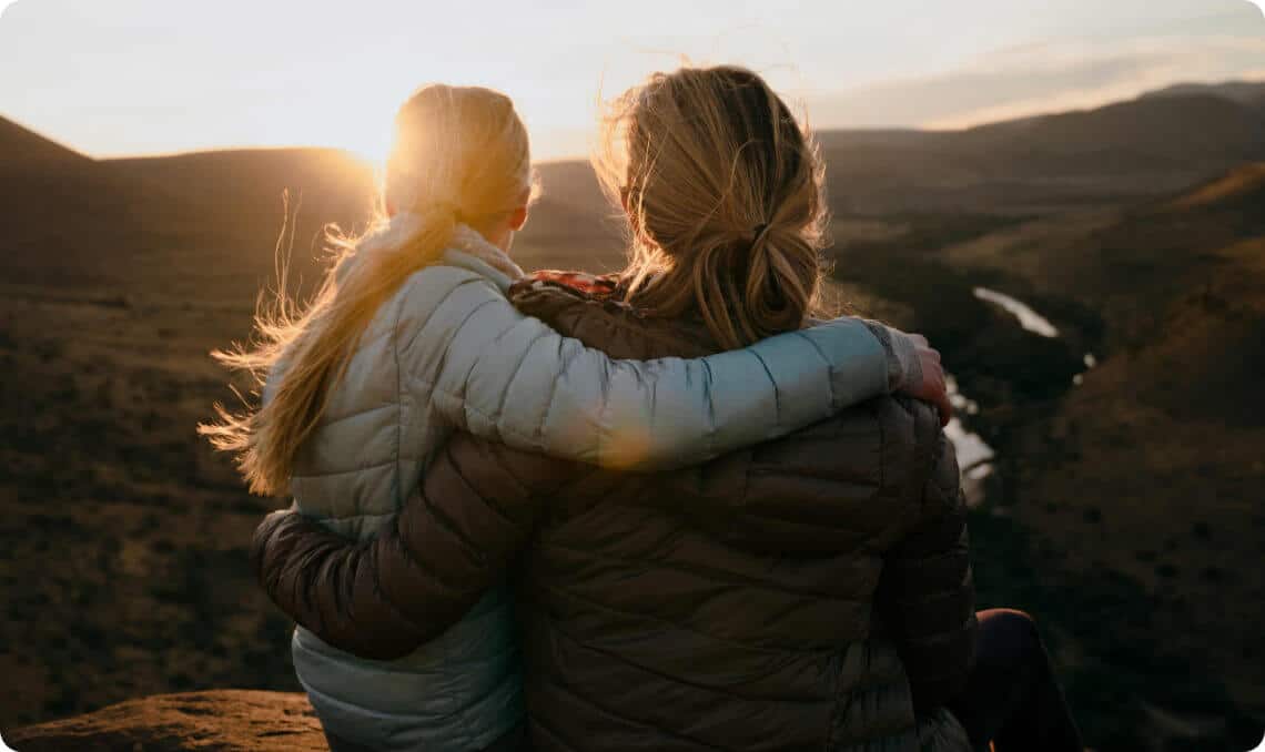 Mother and daughter watching sunset
