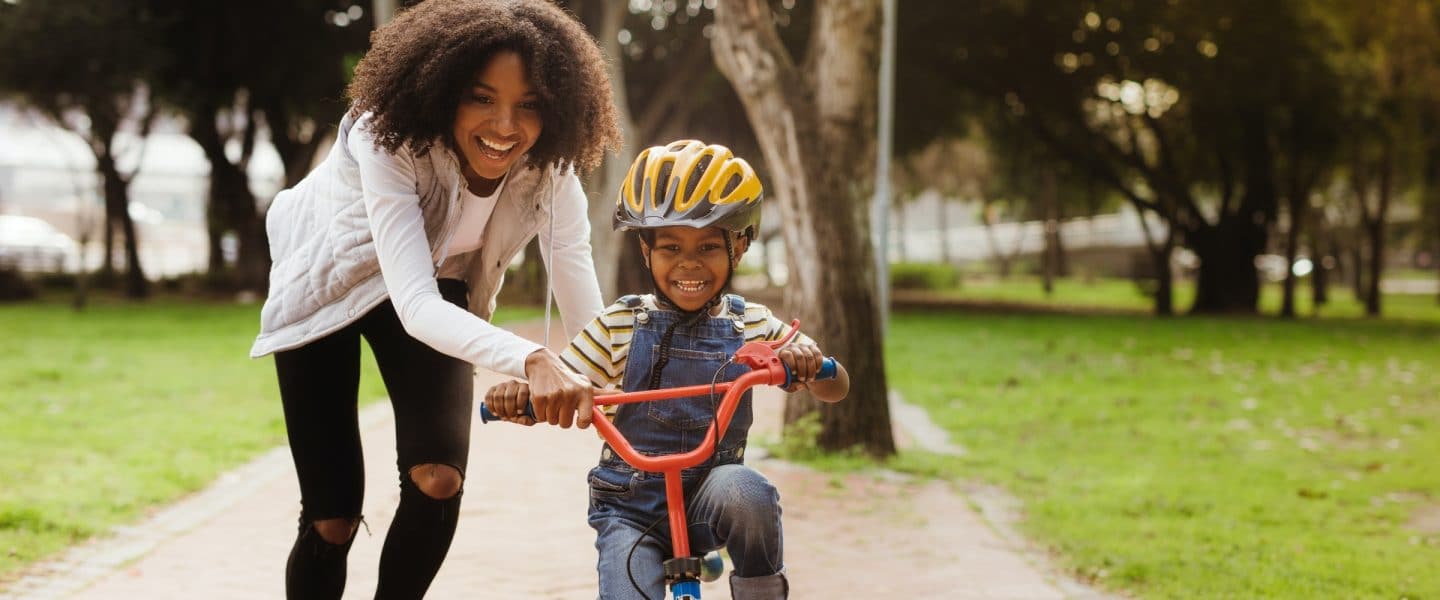 Single parent teaching son to ride bike