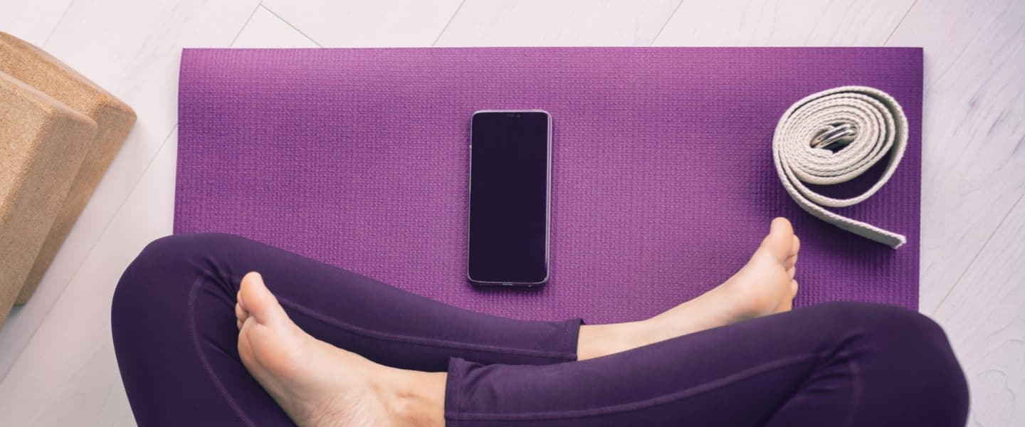 digital self care with phone and yoga mat
