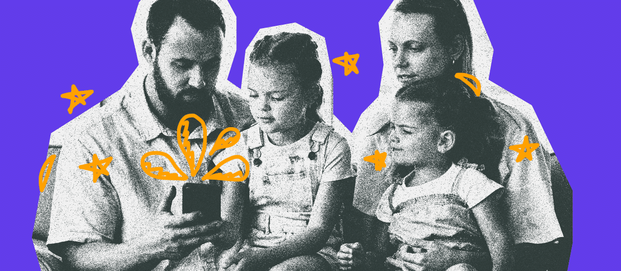 Family of four with dad holding a phone.