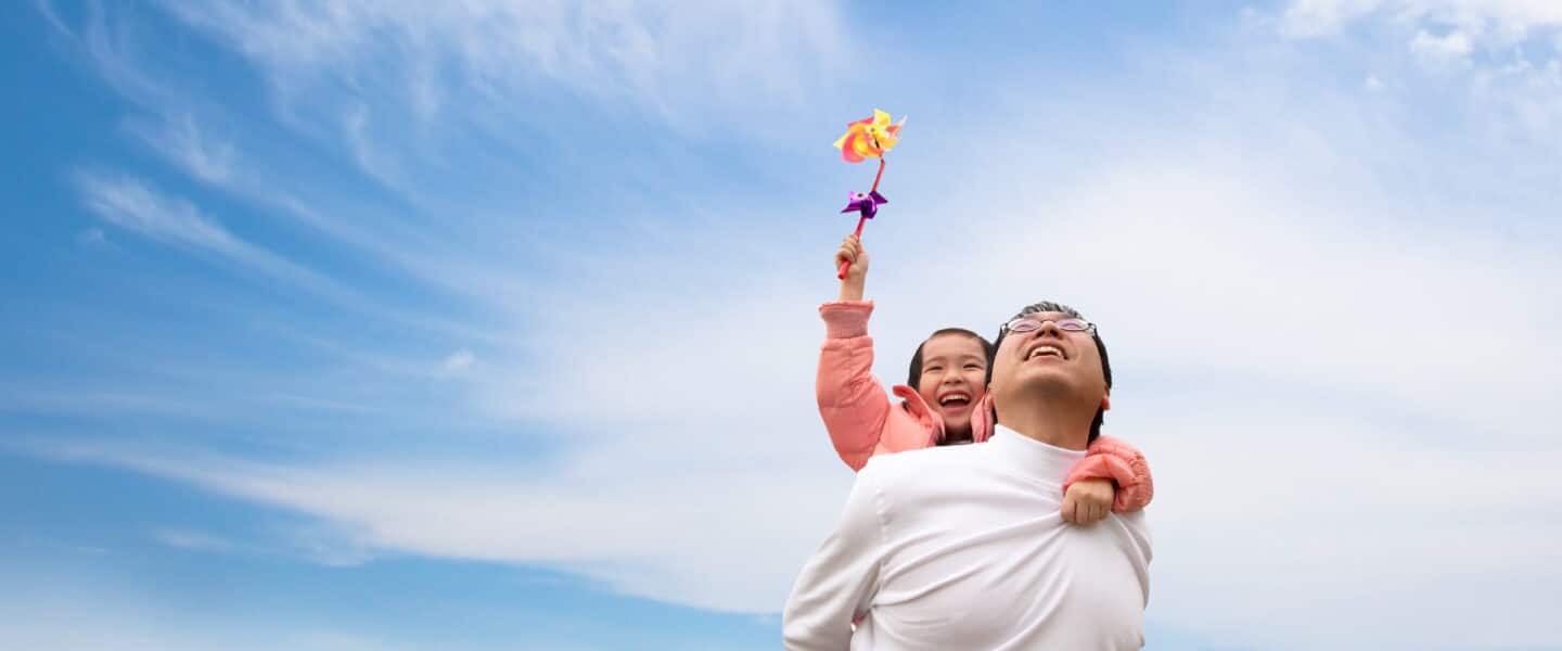 father and daughter looking at clouds