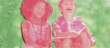A young girl and boy laughing while exploring outside