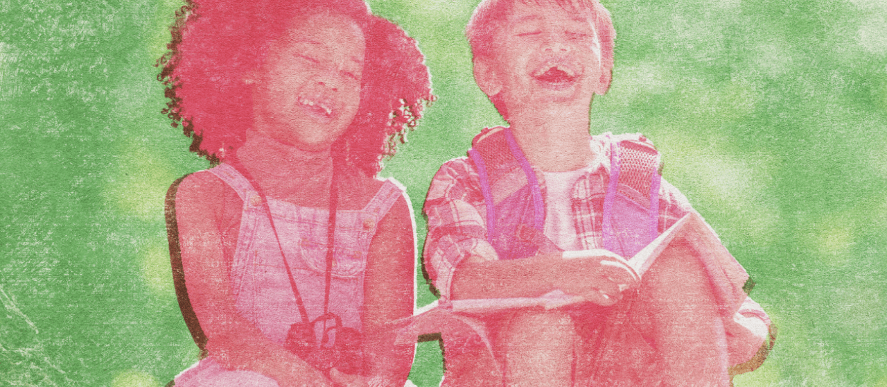 A young girl and boy laughing while exploring outside