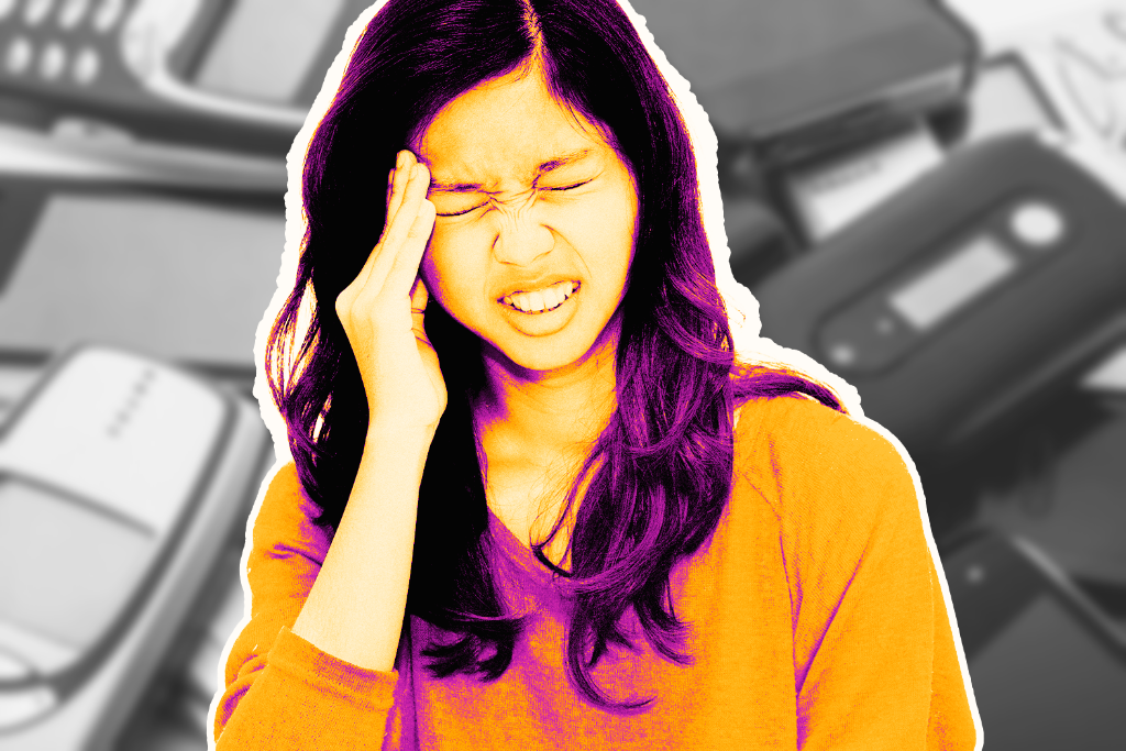 A girl rubbing her head in frustration with phones in the background.