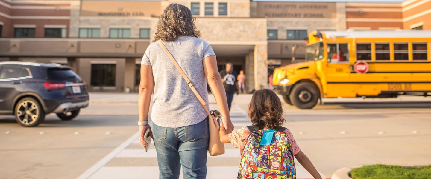 mom and child walking to school