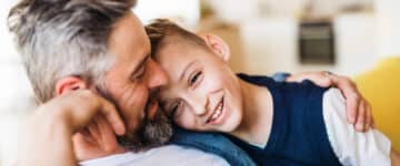 father and son hugging and smiling