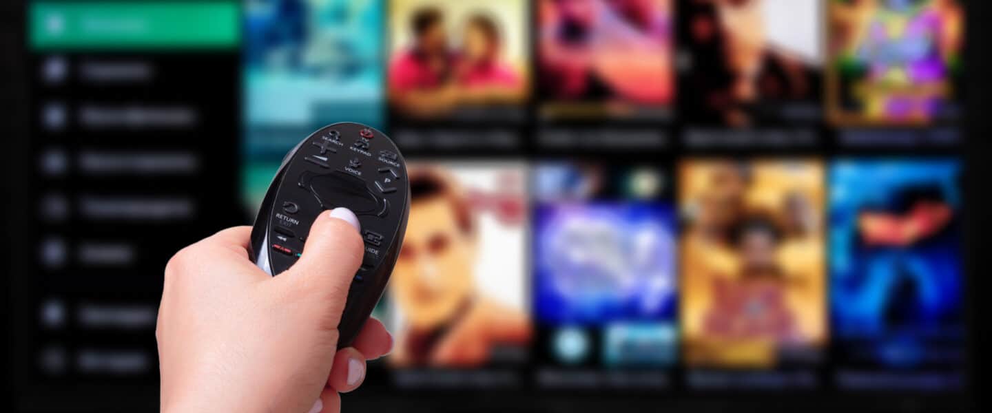 hand with remote watching netflix