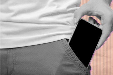 A teen putting his phone in his pocket.