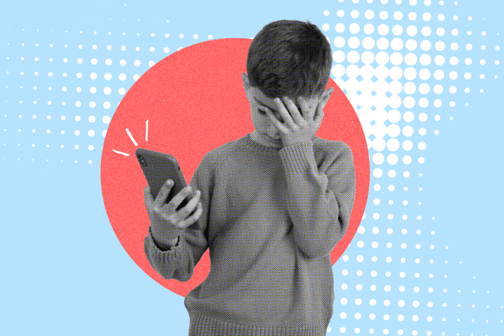 A picture of a young boy on his phone.