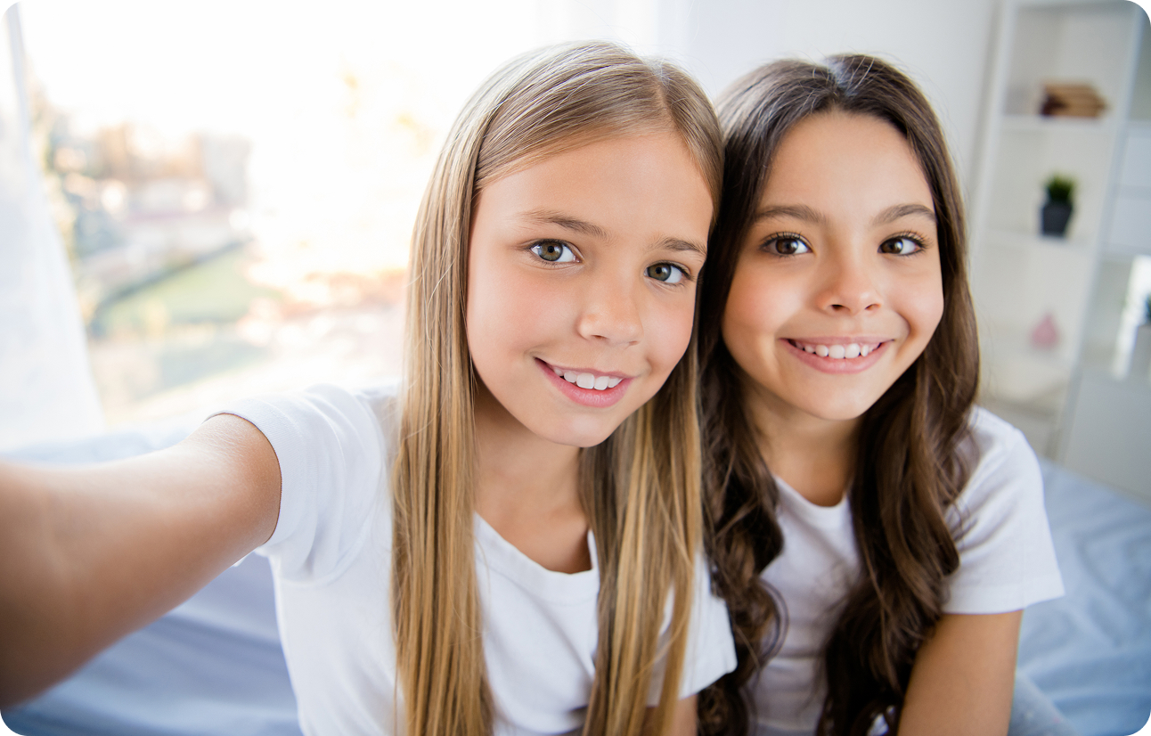 picture of two young girls smiling for a selfie