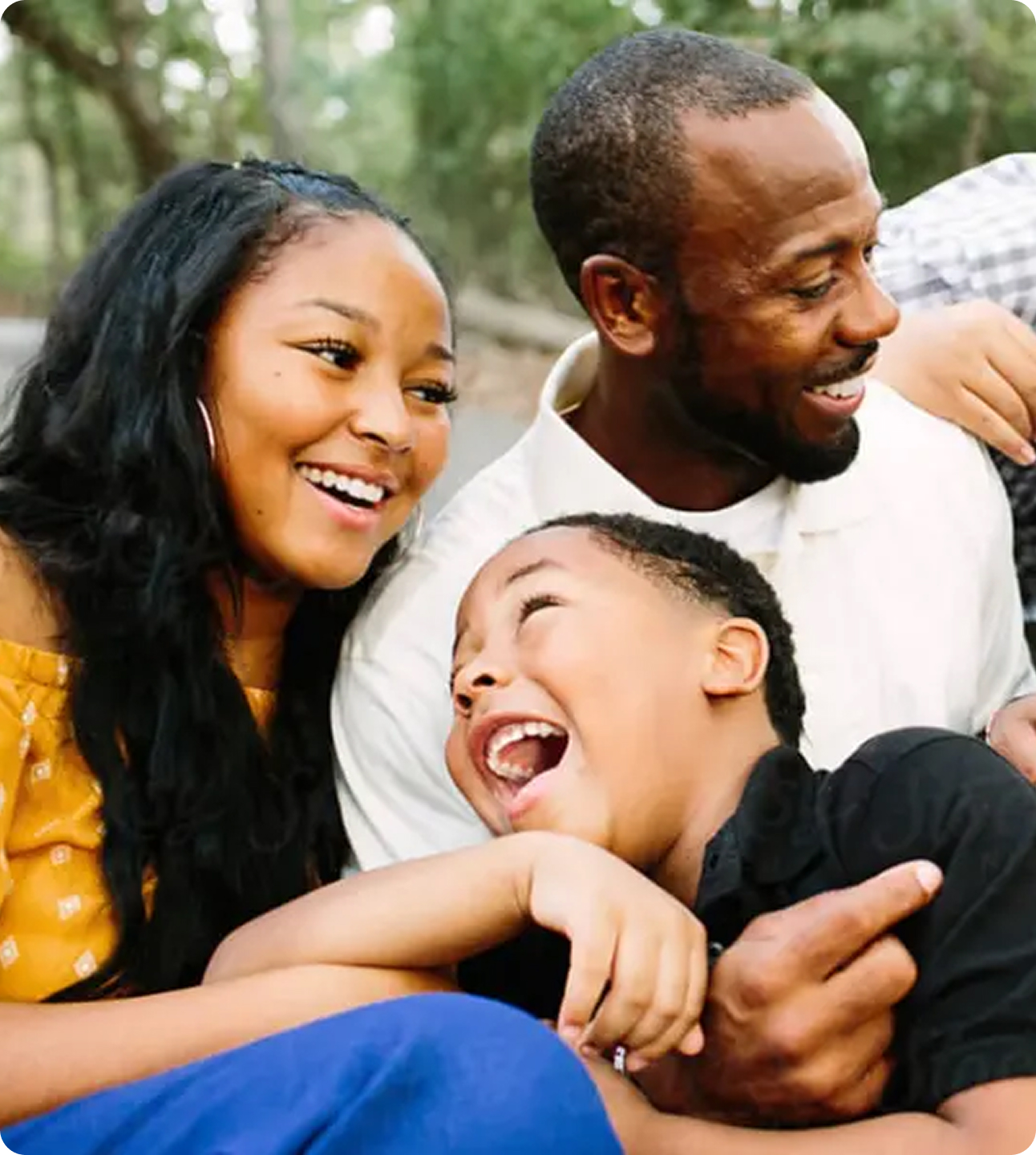 a picture of a father with his son and daughter at an outdoor campsite