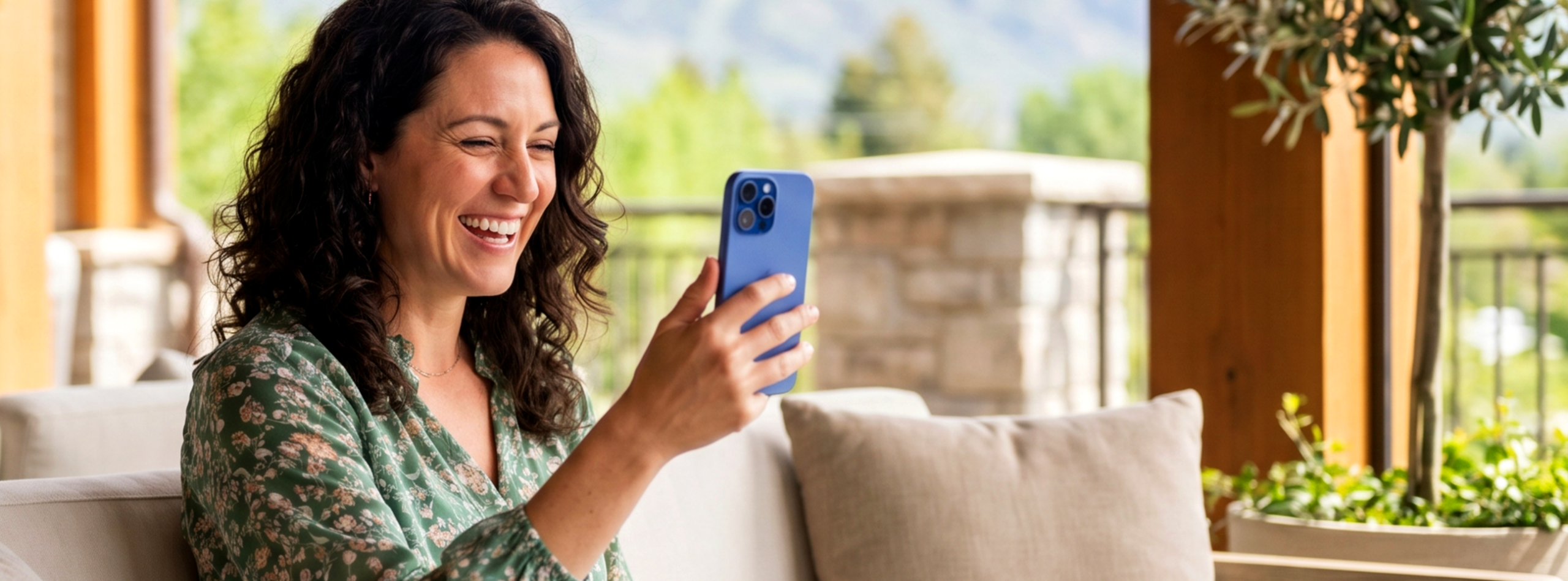 mom smiling on a video call on her phone with her kid