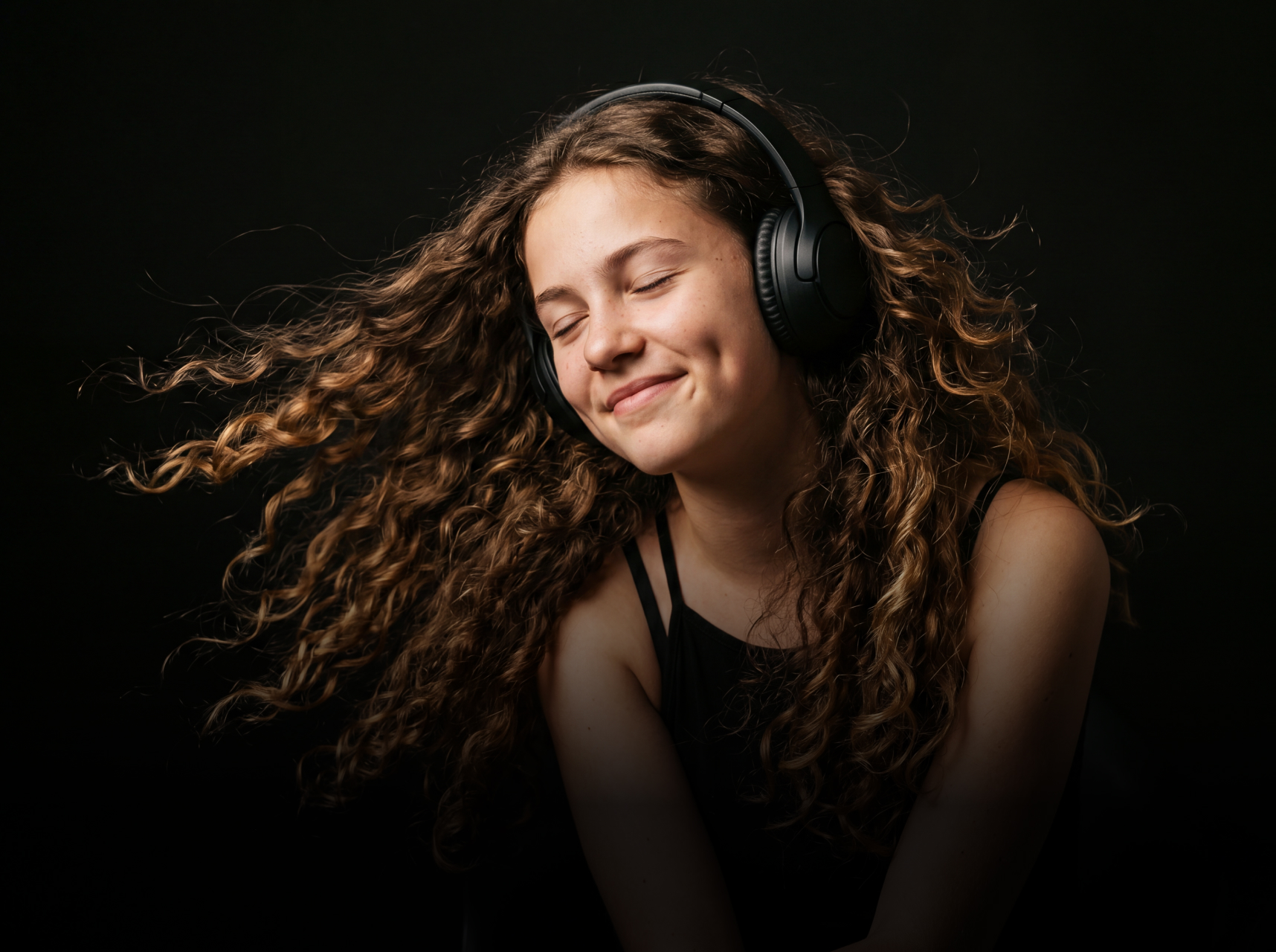 young girl listening to music with headphones