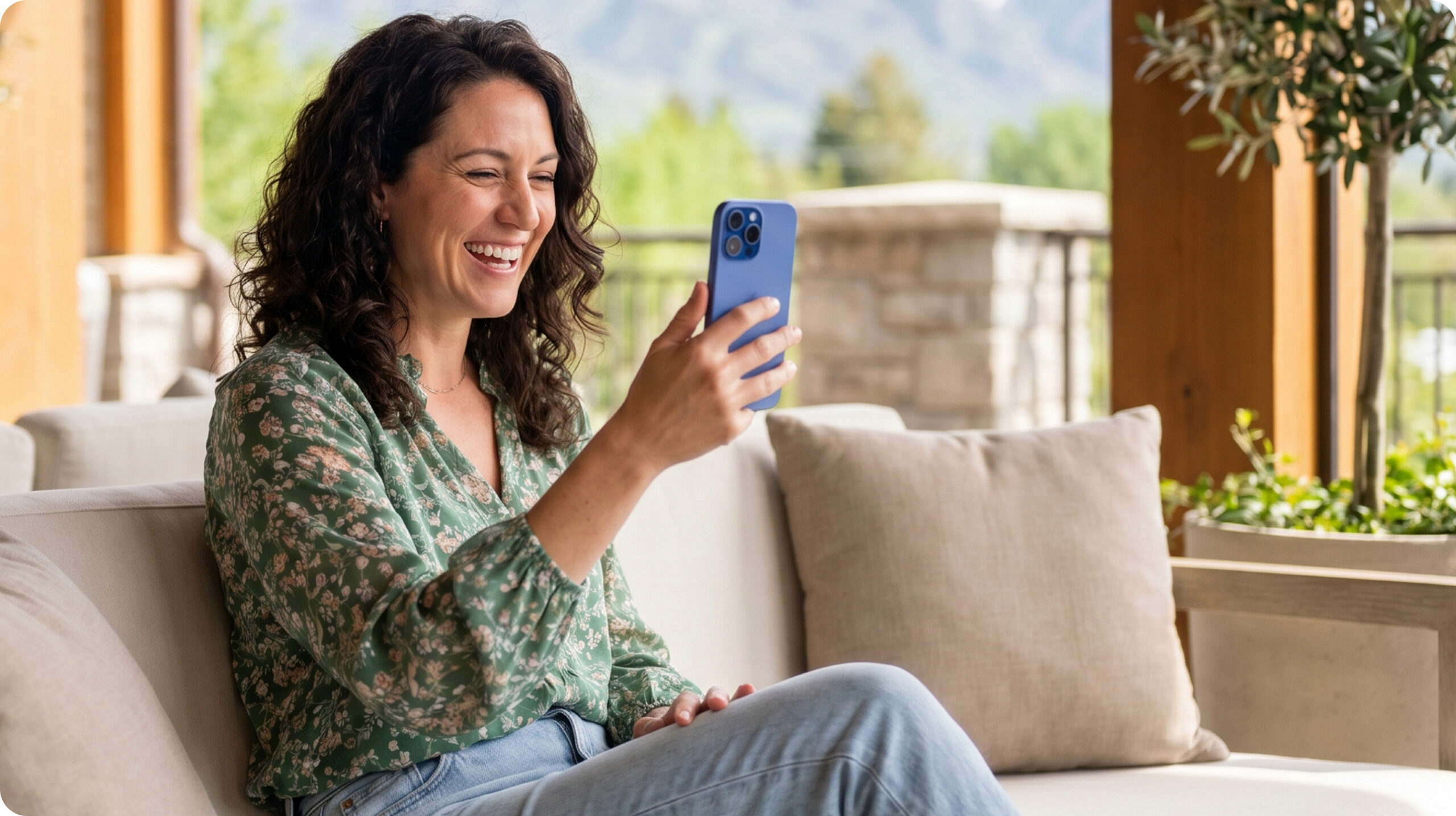 Mother smiling at her phone during a video call