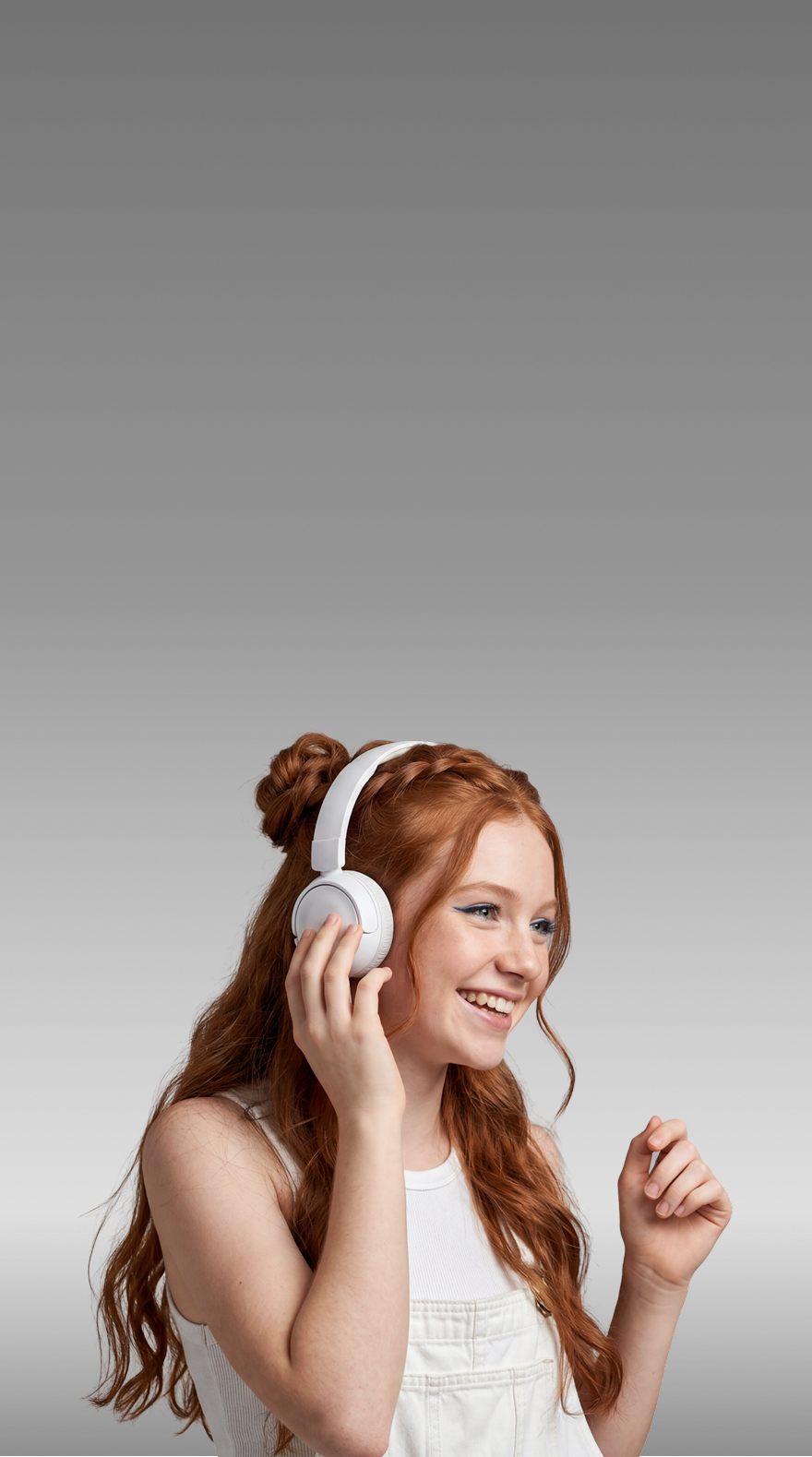 Girl smiling and listening to Gabb Music on headphones